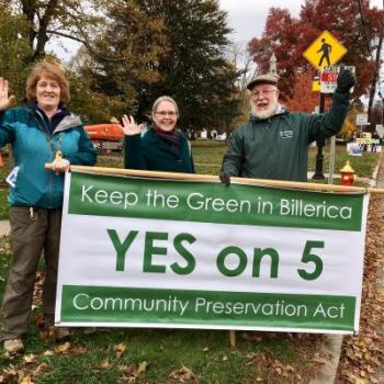 CPA advocates and supporters in Billerica hold a large green and white banner reading "Keep the Green in Billerica - YES on 5 - Community Preservation Act"