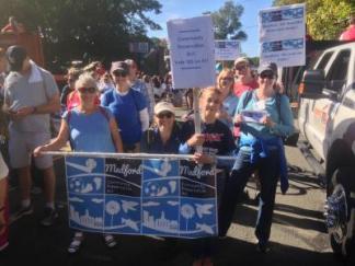 CPA Advocates and supporters in Medford parade around town with signs in support of CPA for Medford
